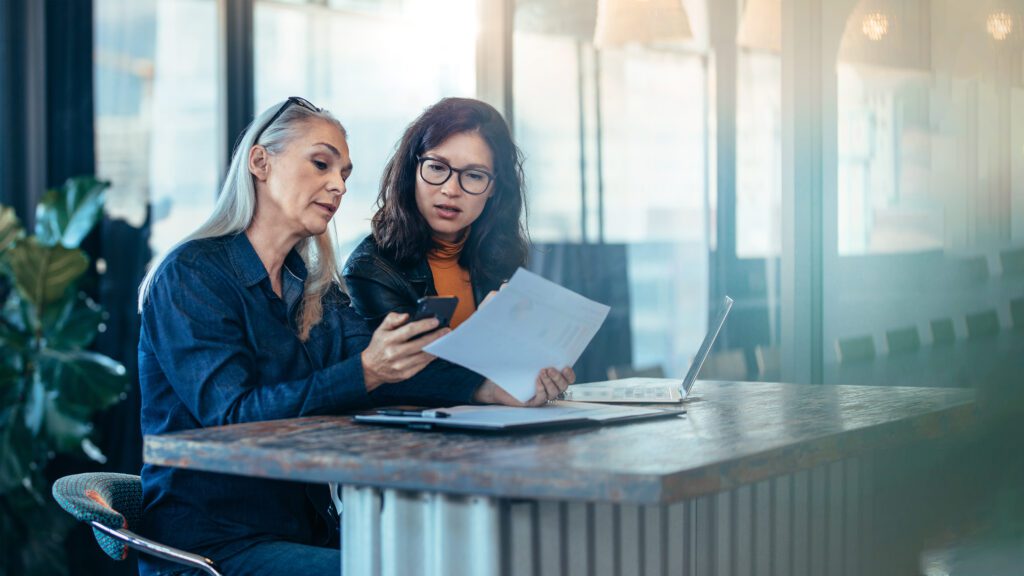 Older woman coaching younger woman