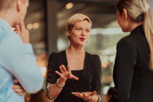 Three people engaged in a conversation