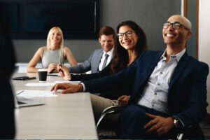 Smiling professionals sitting at a conference table