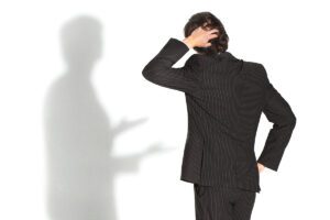 Confused person looking at a shadow