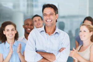 A group of happy people clapping and smiling